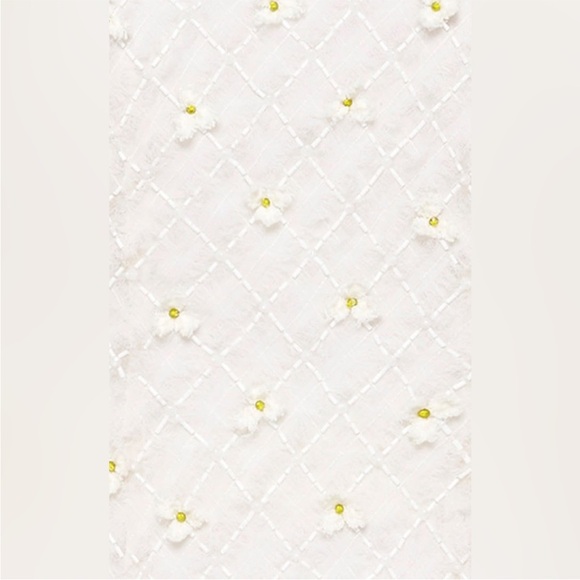 Stunning ivory white open cutting out with delicate flowers cute detailing. - Picture 12 of 16